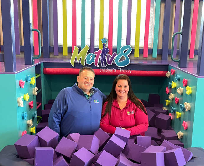 About Us. Chris Anderson and Lorrie Middelstaedt inside their sensory gym foam pit taking fun staff picture. Motiv8 Logo appears above their heads