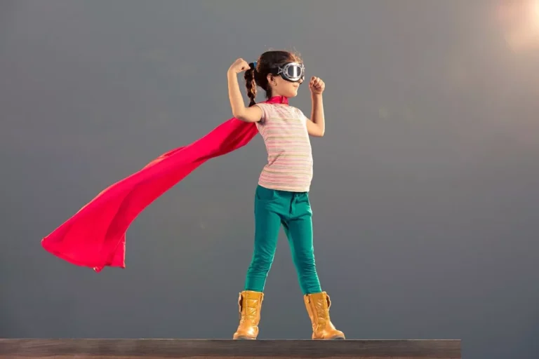 Small girl in superhero pose, showing her independence and interests.